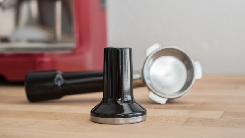 espresso machine - a tamp and a portafilter, tools of the semi-automatic machine.