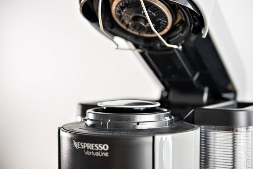 nespresso evoluo - placing the espresso capsule in the machine and closing the top is...