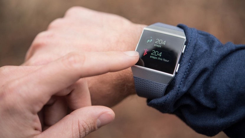 fitbit ionic - you can setup the display to be always on or auto adjust brightness.