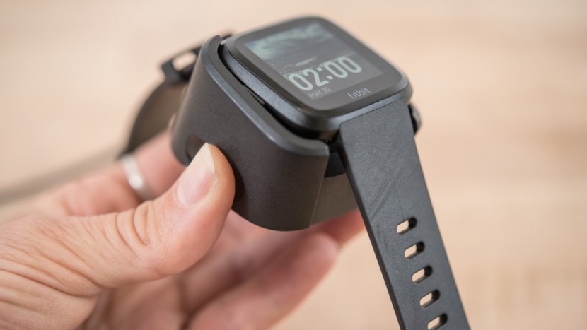 fitbit versa - the charging cradle holds the versa very, very securely.