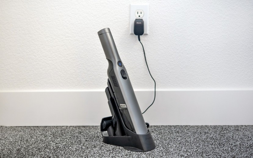 shark wandvac - the wandvac has spots on its charging base to store attachments.
