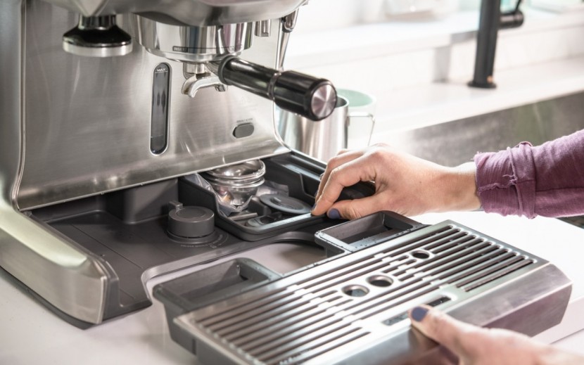 breville the dual boiler - pulling back the drip tray reveals a compartment for accessories...
