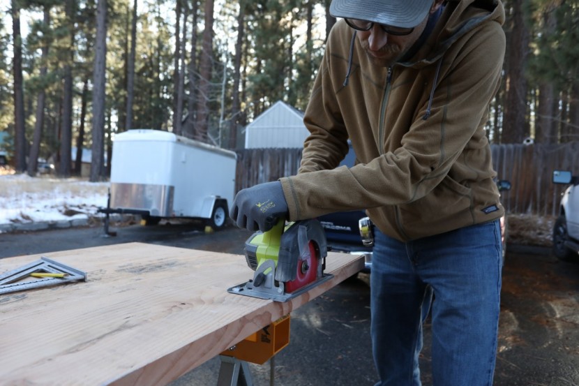 cordless circular saw - the ryobi p507 ripping the 10&#039; length of a 2x12&quot; softwood plank. the...