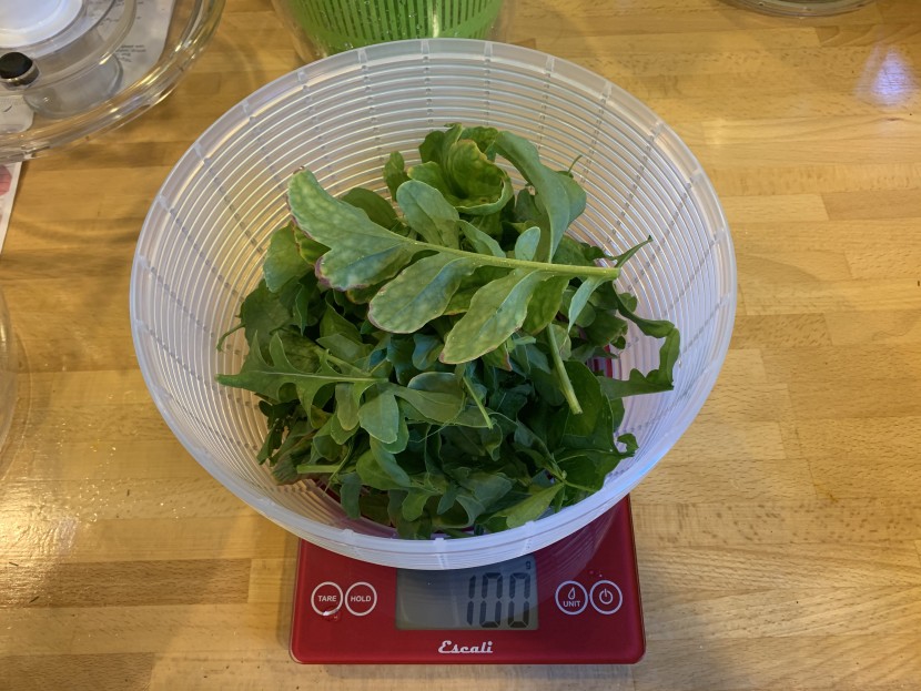 salad spinner - precisely weighing out arugula for the water removal test.