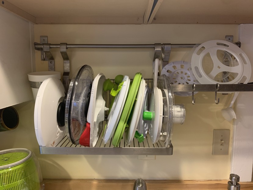 salad spinner - all nine lid tops stacked side by side.