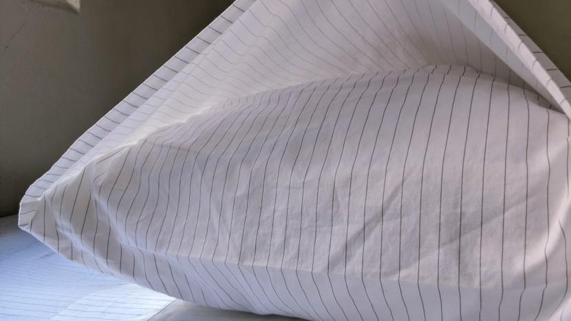 the brooklinen pillowcases have an envelope design that not only fit...