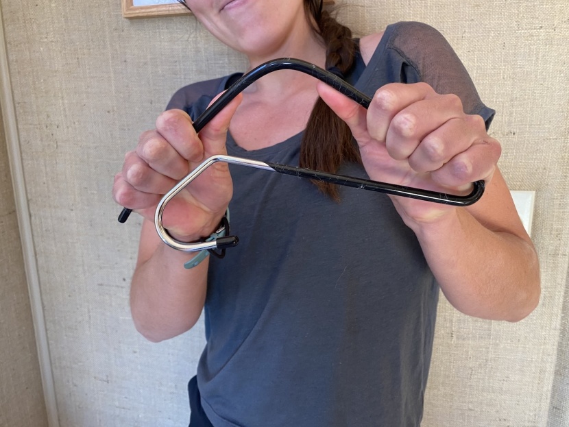 clothes hangers - roz tries her hardest to bend this bomber hanger out of shape. while...