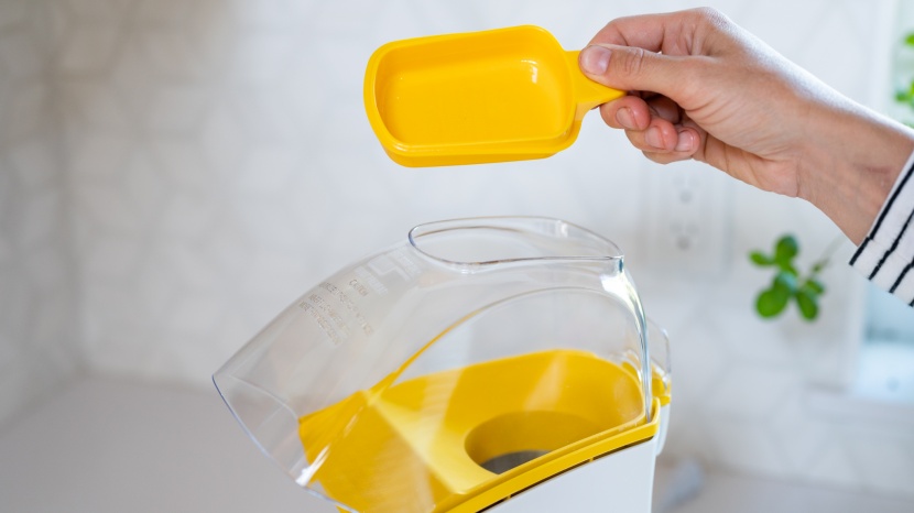 popcorn popper - the measuring scoop doubles at a butter melter.