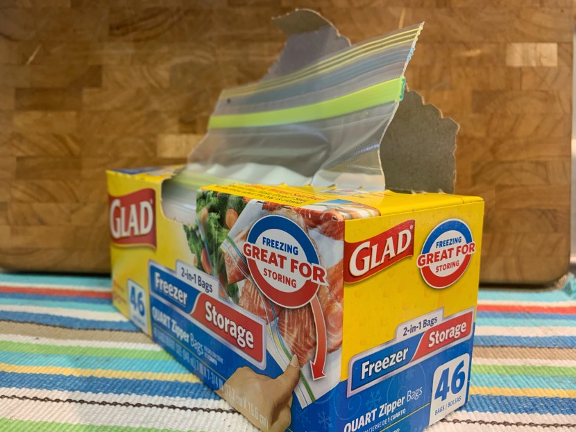 the glad 2-in-1 bags dispense from a standard perforated hole on top...