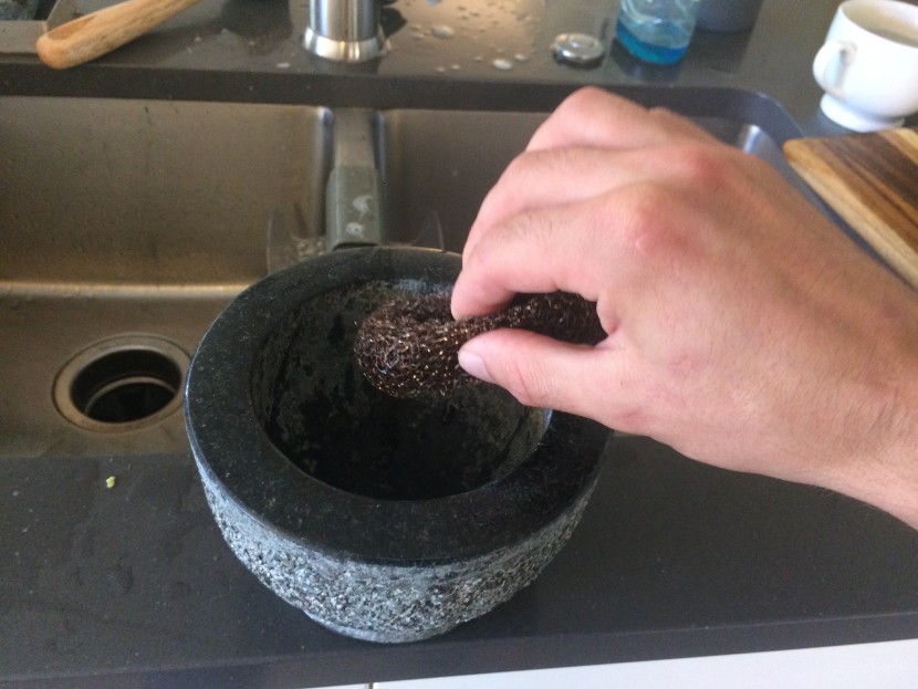 mortar and pestle - using steel wool to clean the hicoup unpolished granite set.