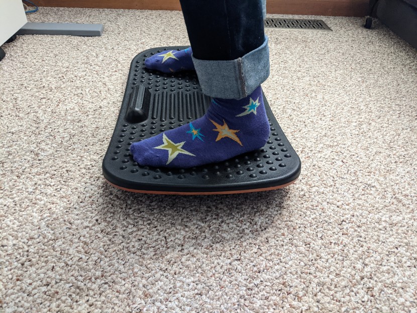 standing desk mat - the fezibo is a wobble board with a gentle rocker and massage beads.