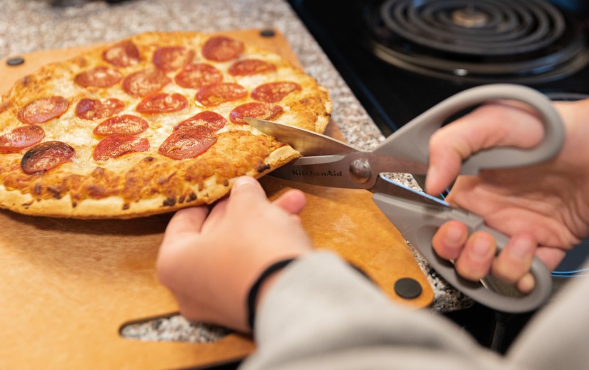 the kitchenaid all purpose shears cutting up a pepperoni pizza.