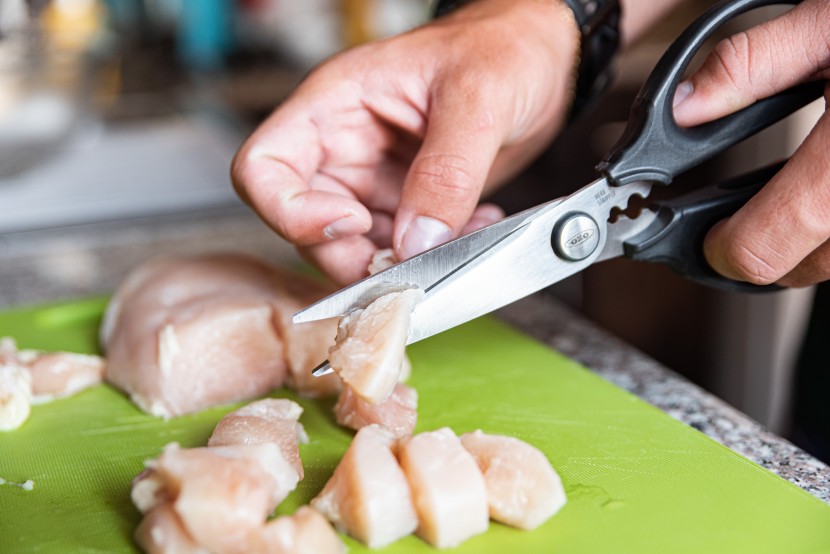 kitchen shears - the oxo good grips multi-purpose scissors slicing through a slippery...