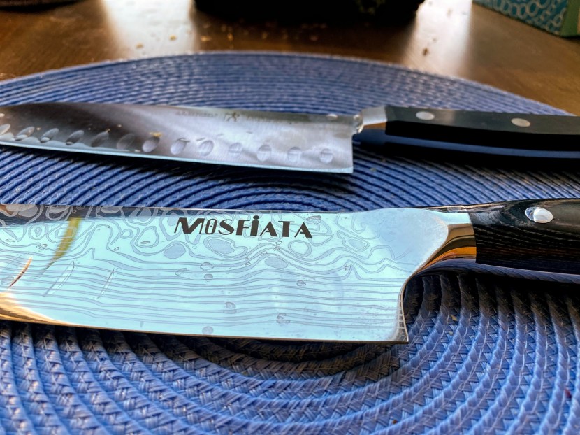 santoku knife - the bolster of the knife in the foreground is smooth, gentle, and...