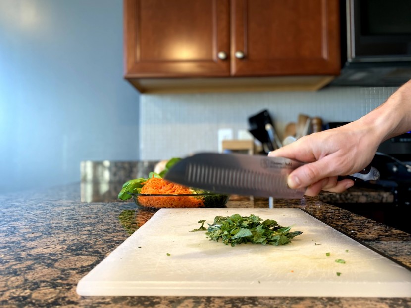 santoku knife - for one of our tests, we chop herbs with each knife and observe any...