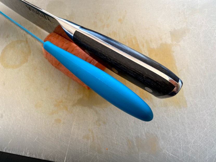 santoku knife - the knife on top has a fuller, rounder handle that conforms well to...