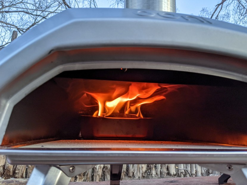 ooni karu 12 - the classic rolling flame of a wood-fired oven, spilling out over...
