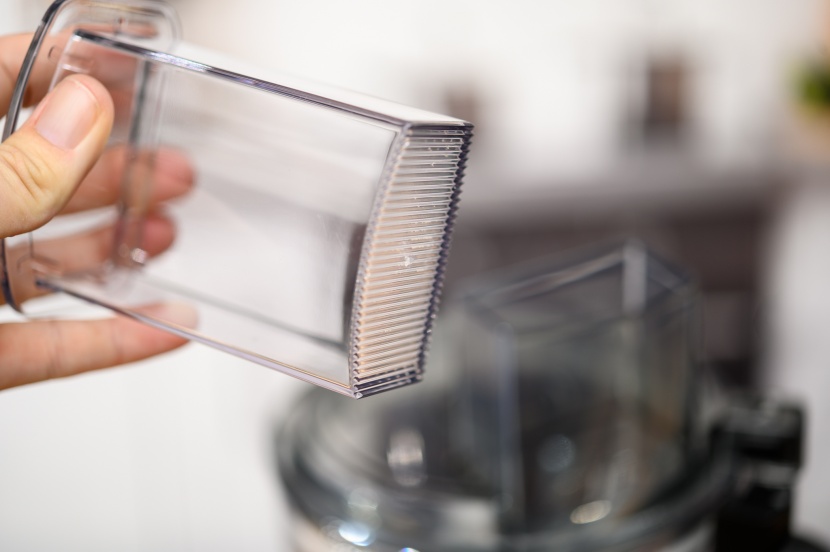 ninja professional food processor - the push tube has a small hole for dispensing liquids slowly.