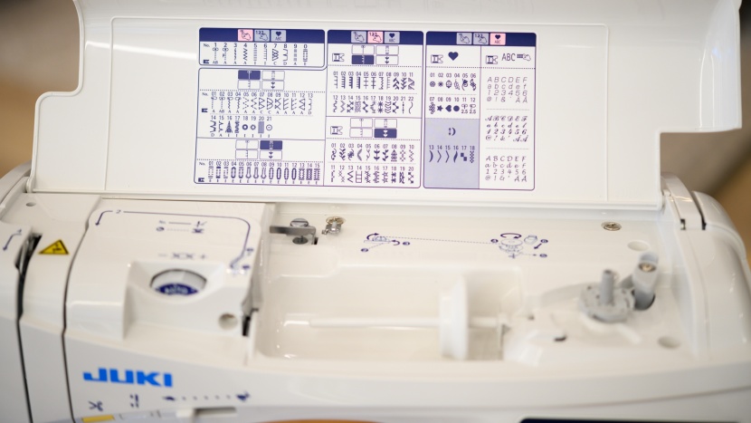 the flip-up panel on top of the machine shows the multiple stitches...