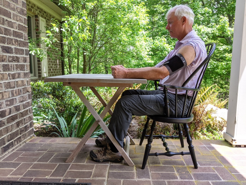 blood pressure monitor - dr. glen tate demonstrates proper blood pressure-taking posture...