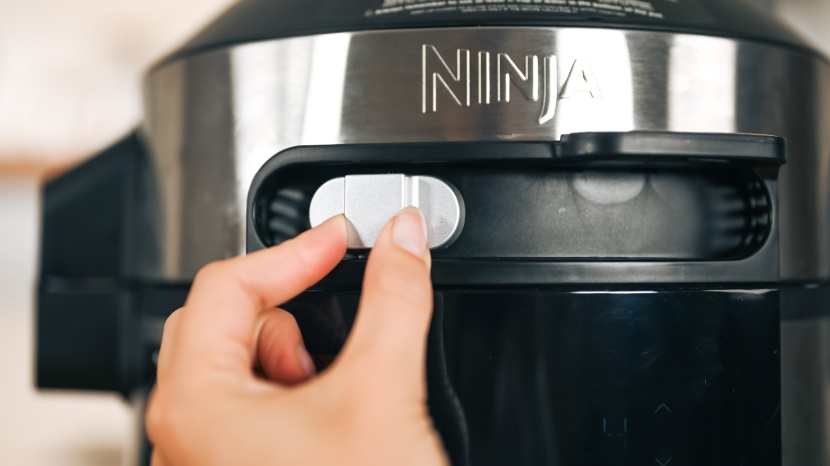 ninja foodi smart xl - a slider switch, which sits above the control panel, moves...