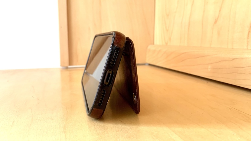 the onetop wallet's leather flap doubles as a kickstand.