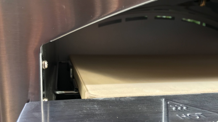 the pizza stone sits on top of a grate above the distribution cap...