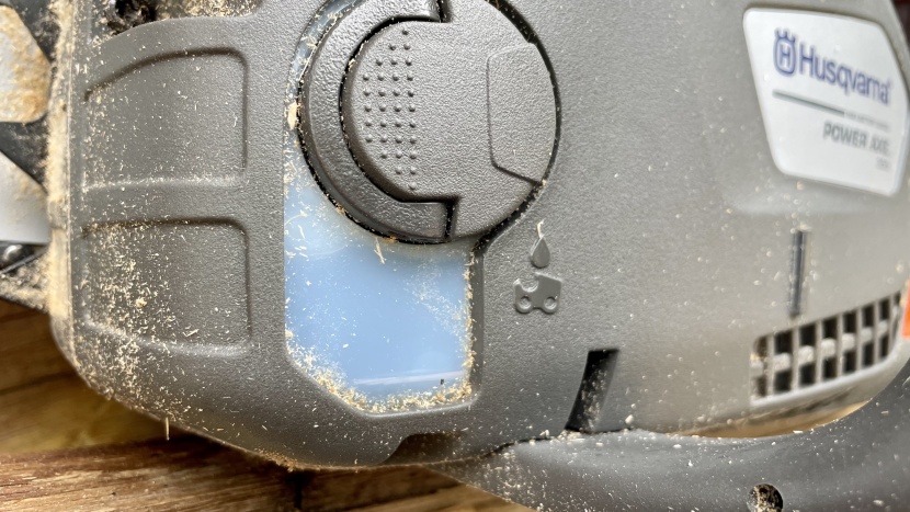 between the fold-out lever on the cap and the plastic window, the...