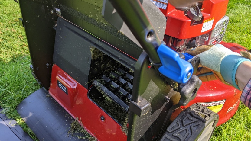 to switch between mulching and bagging modes, open the trap door in...
