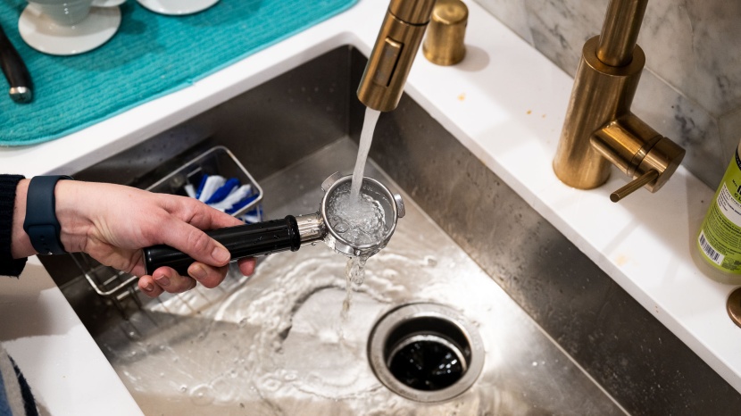 breville barista express - rinsing out our portafilter after pulling a shot.