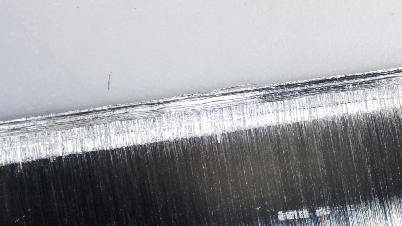 an up-close shot of a knife blade pulled through the sharpal 6-in-1...