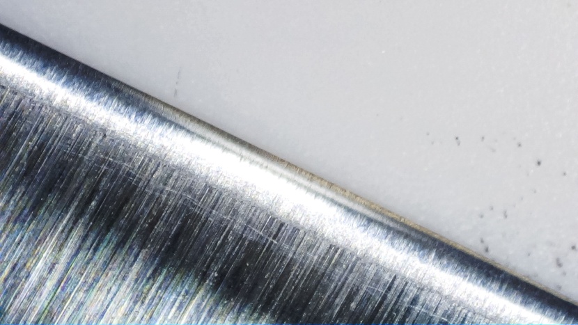 a close-up of the edge of a knife sharpened by the ken onion reveals...