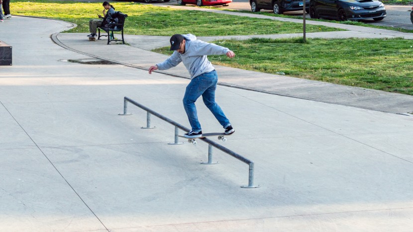 jackson holding onto a backside lipslide on a round rail at the...