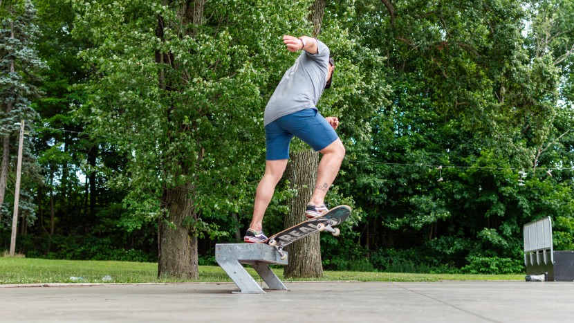jackson holding the pinch for the backside krooked grind on a metal...