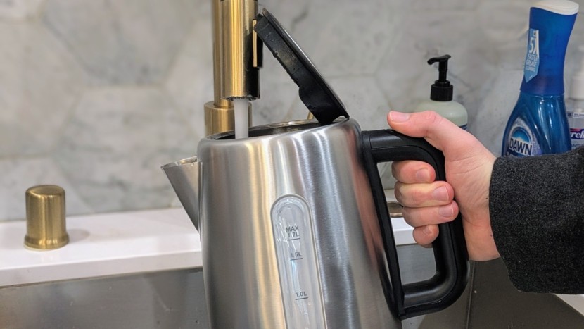amazon basics electric kettle - notice how the lid of the amazon basics is touching the faucet in...