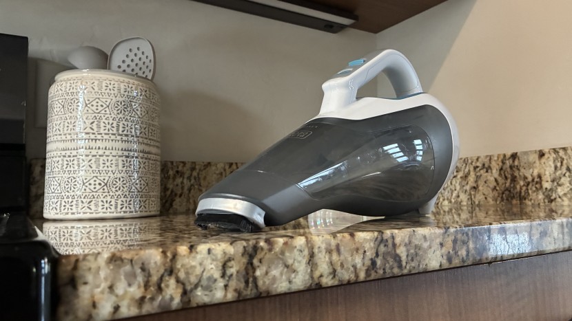 handheld vacuum - the short, stiff bristles of this attachment are helpful, but hair...