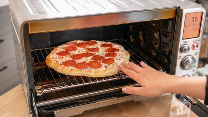 breville smart oven air fryer pro - the convection fan helps cook pizza evenly and it can even fit a...